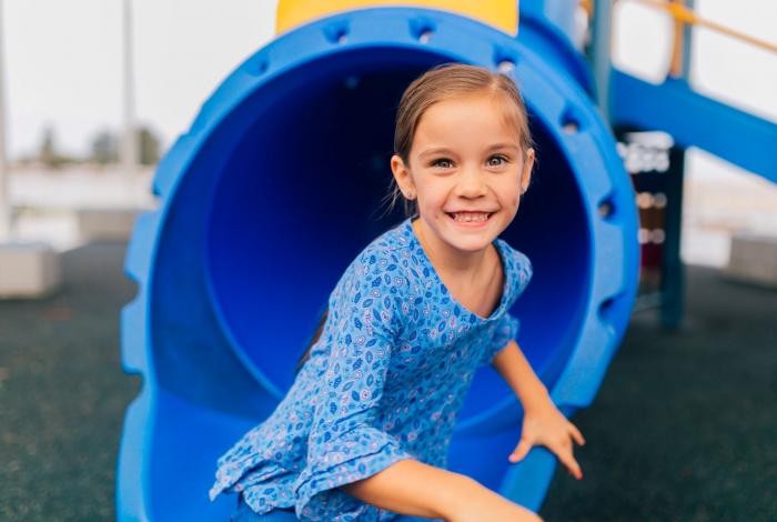 Young girl on a slippery dip